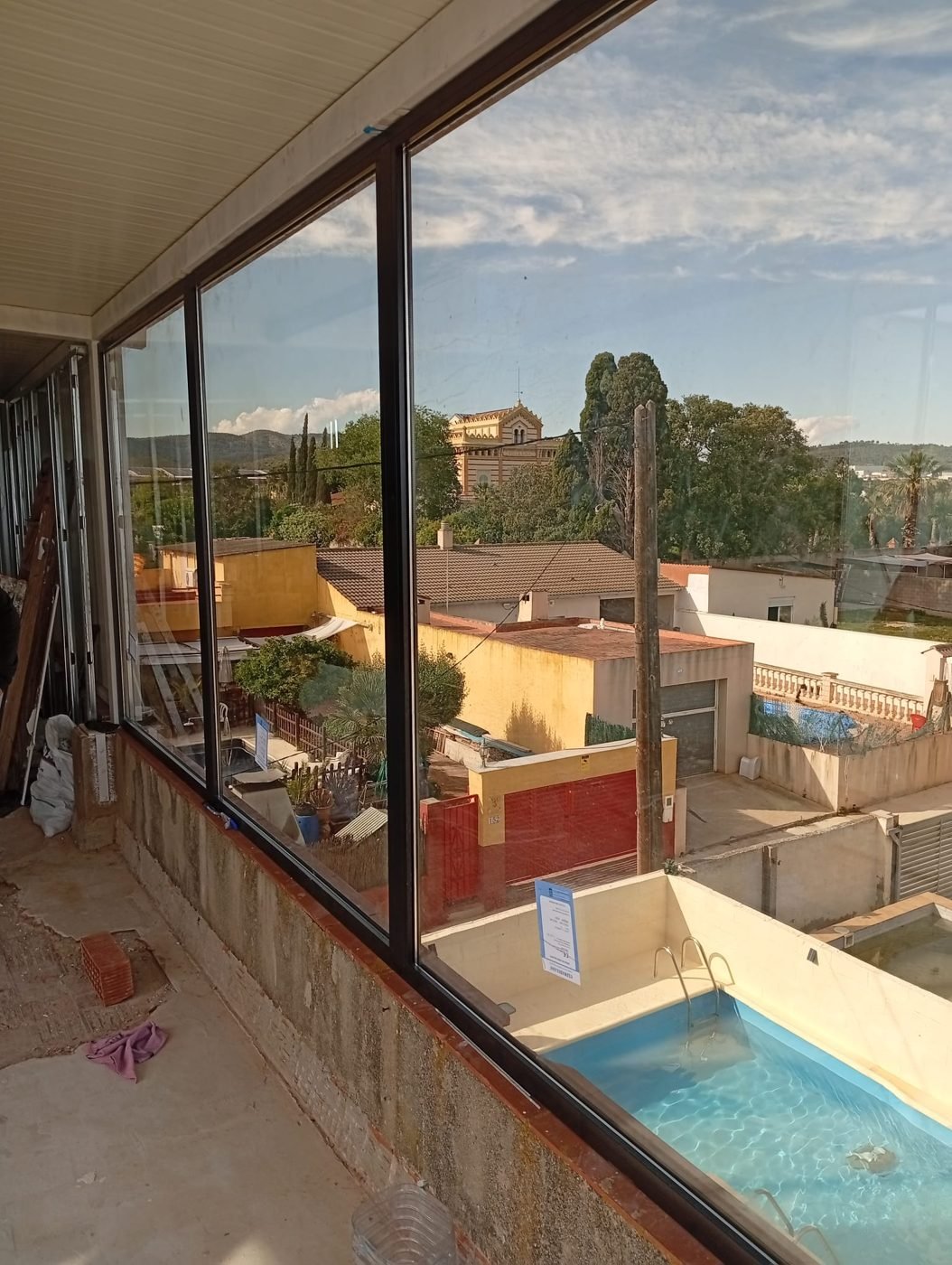 Ventanal de aluminio con vistas a una piscina